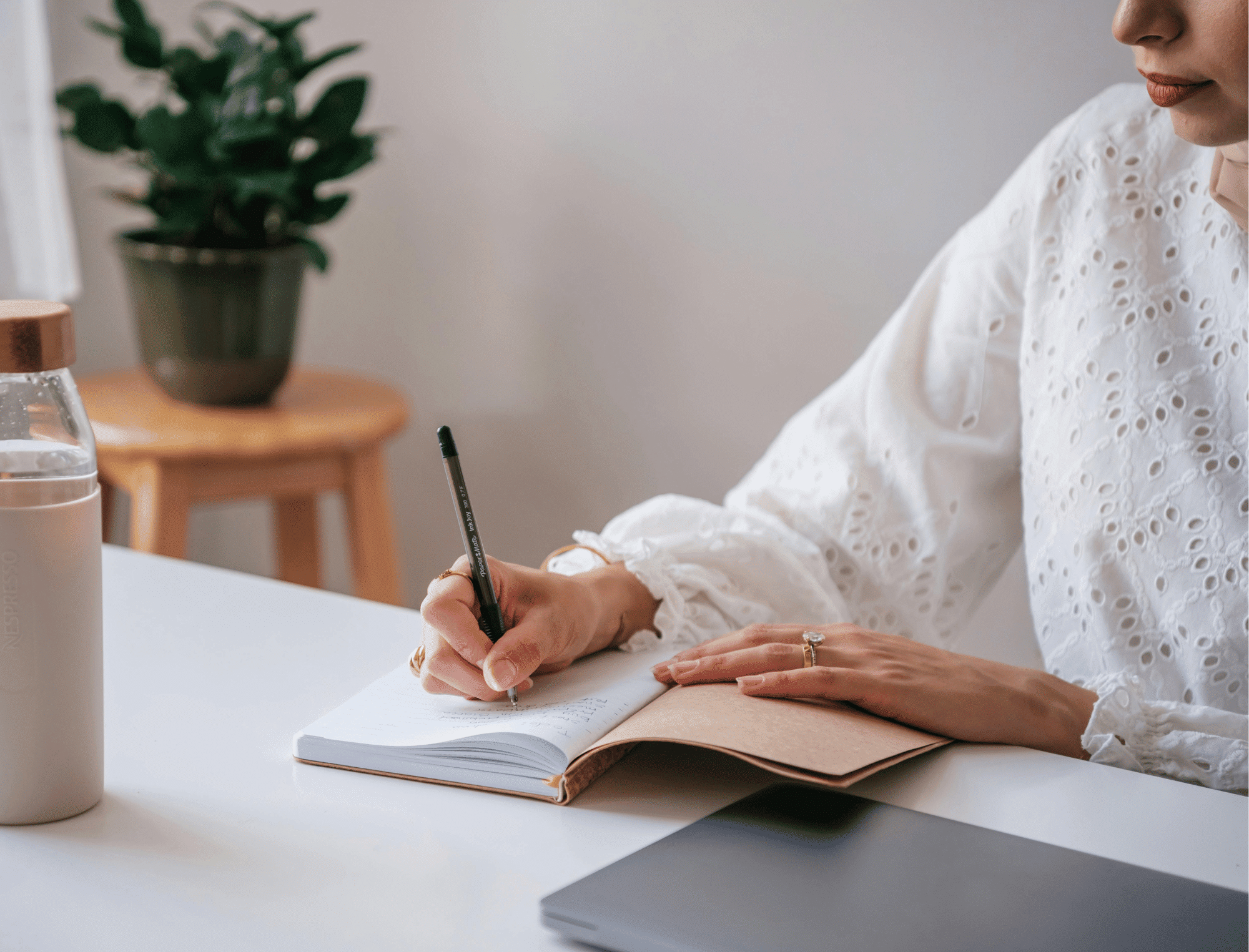 Woman writes in a notebook with a pen. Begin your personal story with this writing technique.